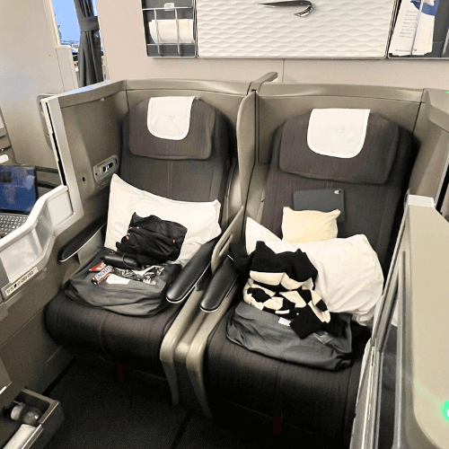British Airways A380 business class middle seats | Journey Beyond 40 a spacious business class seat on a british airways a380, featuring luxurious seating, ample legroom, and a sleek, modern design.